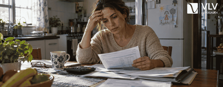 Pensão compensatória: quem tem direito após o divórcio 1 Mulher analisando extratos e documentos financeiros para pensão compensatória após o divórcio